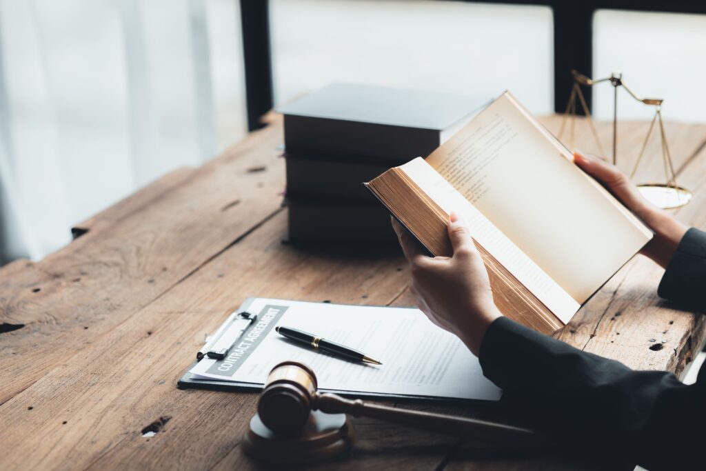 A lawyer reviewing legal books and resources to stay updated with current laws.