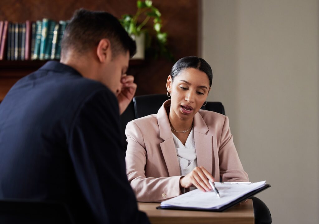 A professional divorce attorney explaining legal documents to a client.