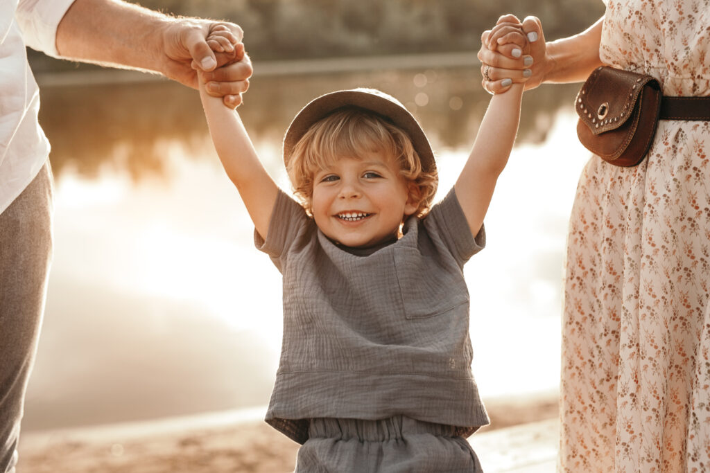 Child enjoying quality time with both parents, highlighting joint custody.