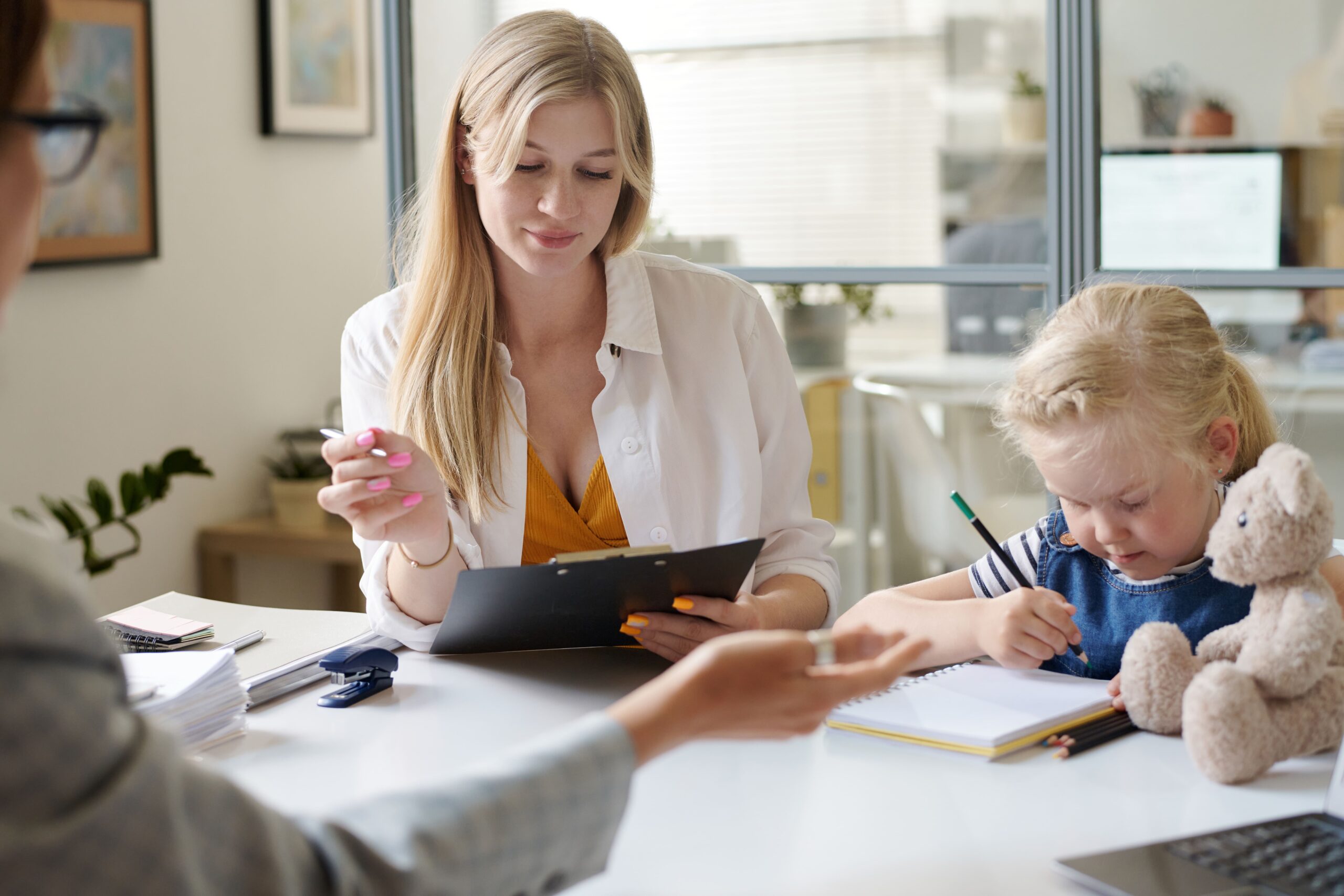 young mom with child visiting to social worker